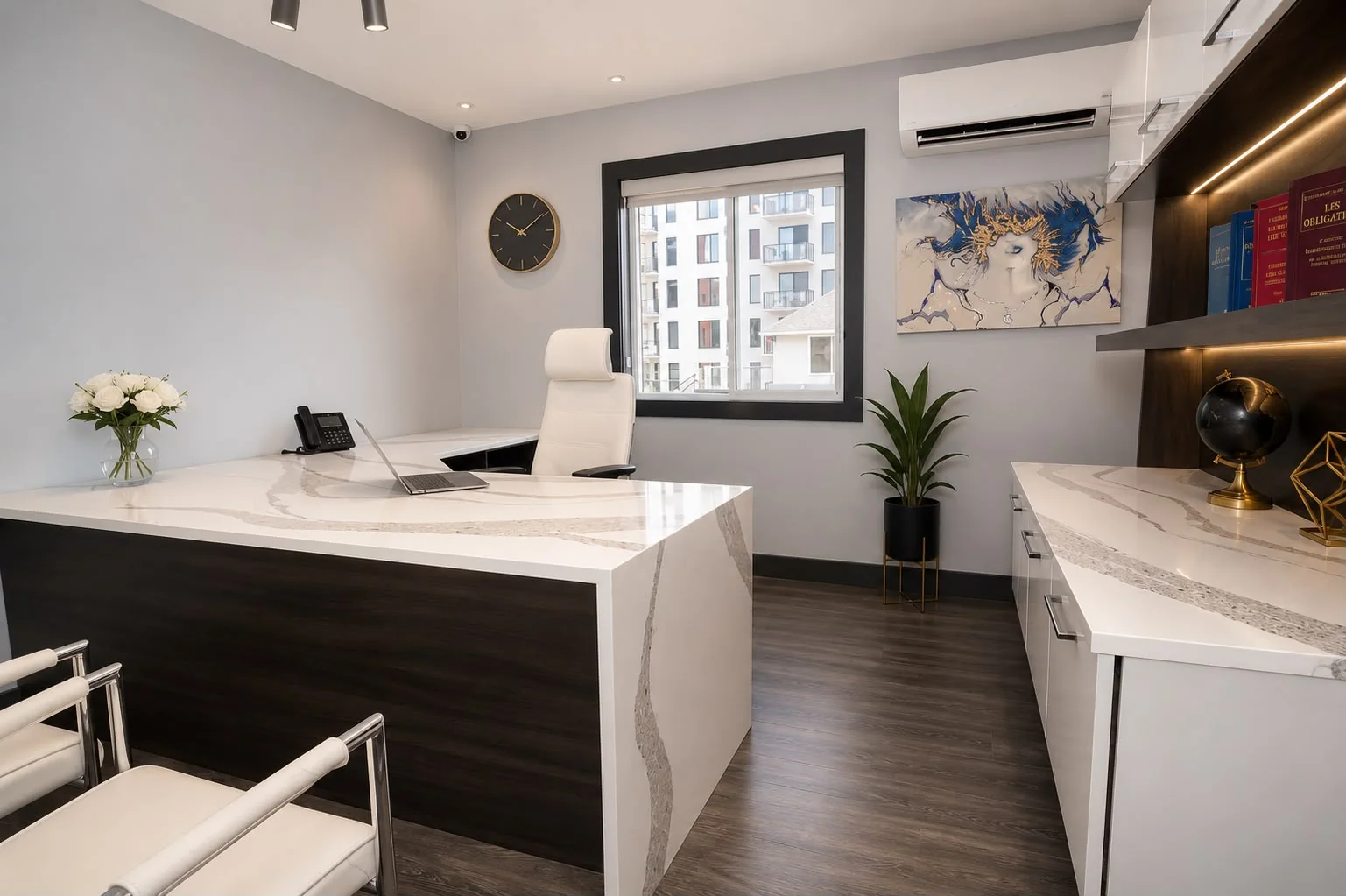 Executive office with a veined quartz counter and lit bookcase