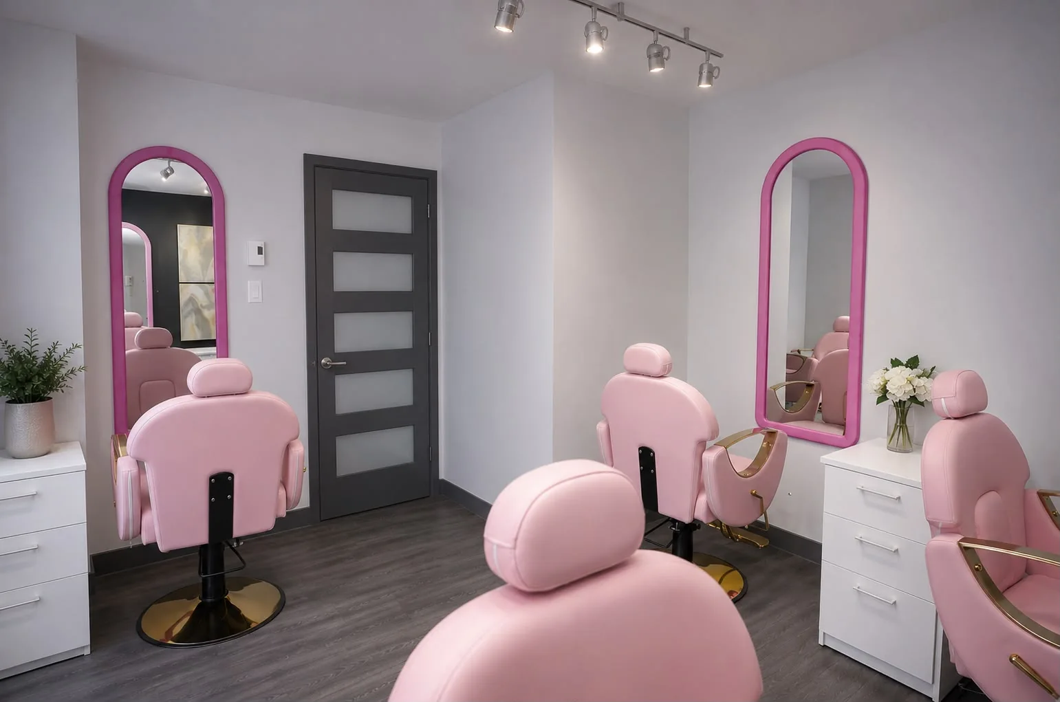 Hair salon with pink styling chairs and arched fuchsia mirrors